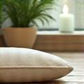 A serene scene with a meditation cushion and essential oils