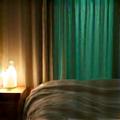 Image of a serene bedroom with calm lighting and sleep aids