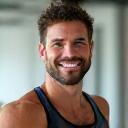 Mark Thompson, a male fitness coach, smiling
